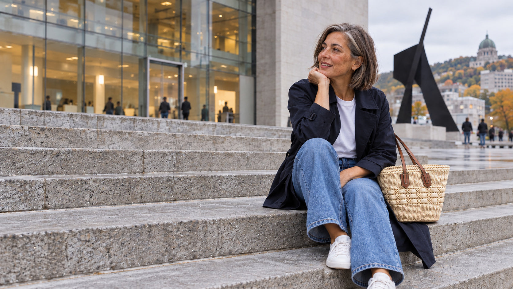 A woman with the ivory Duna basket tote on city steps â€” Emma Market